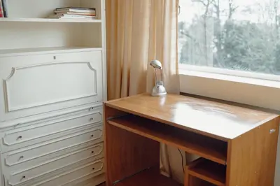 a home office with a desk and a window at Grand Botanic Garden Apartment by Vacationy in Porto