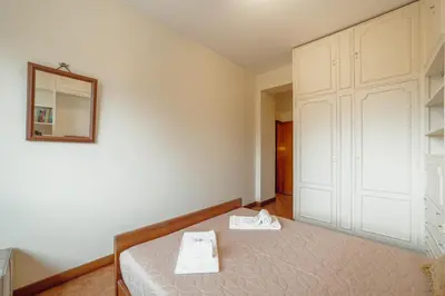 a bedroom with a bed and a mirror at Grand Botanic Garden Apartment by Vacationy in Porto