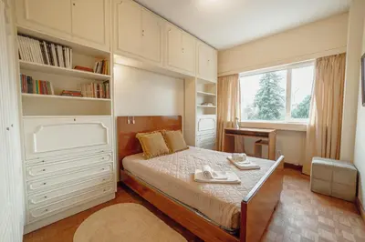 a bedroom with a bed and a large window at Grand Botanic Garden Apartment by Vacationy in Porto