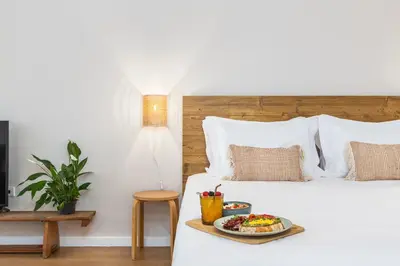 a bed with a plate of food on it at Dream On - Clérigos Lofts in Porto