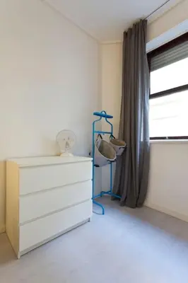 a bedroom with a dresser and a window at Aposentus - Breiner Apartment in Porto