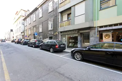a row of cars parked on the side of a street at Aposentus - Breiner Apartment in Porto
