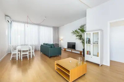 a living room with a green couch and a table at Dream On - Almada Lofts in Porto