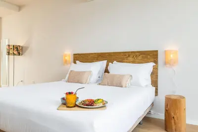 a tray of food on a bed with a plate of food at Dream On - Almada Lofts in Porto