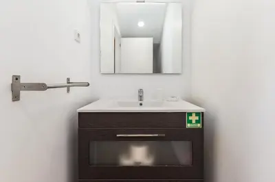 a bathroom with a sink and a mirror at Dream On - Almada Lofts in Porto