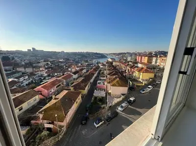 a white bathroom with a sink and a mirror at HEART OF THE CITY 1 ! in Vila Nova de Gaia