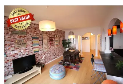 a living room with a brick wall at HEART OF THE CITY 2! in Vila Nova de Gaia