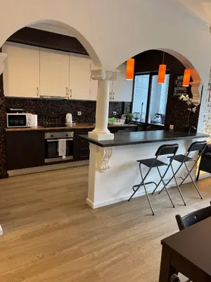 a kitchen with a counter and two stools in a room at HEART OF THE CITY 2! in Vila Nova de Gaia