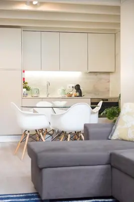 a living room with a couch and white cabinets at Casa Barros - Miragaia in Porto