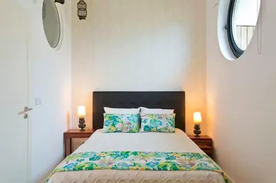 a bedroom with a large bed with two lamps at Urban Cabin in Vila Nova de Gaia
