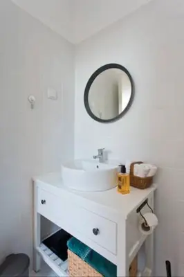a bathroom with a white sink and a mirror at Urban Cabin in Vila Nova de Gaia