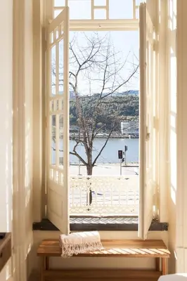 an open window with a view of a beach at VIVA Alameda Suites - River Guest House in Porto