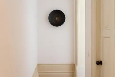 a clock on a wall next to a door at VIVA Alameda Suites - River Guest House in Porto