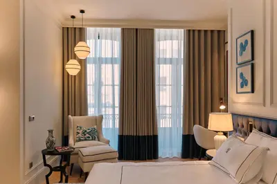 a living room with a couch and a table at GA Palace Hotel & Spa, a XIXth-Century Villa in Porto