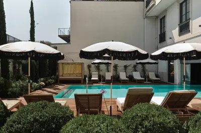a bedroom with a large bed and a living room at GA Palace Hotel & Spa, a XIXth-Century Villa in Porto
