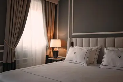 a living room with a white couch and a window at GA Palace Hotel & Spa, a XIXth-Century Villa in Porto