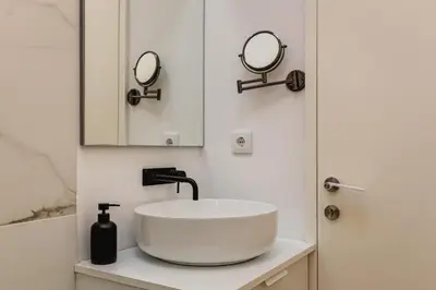 a bathroom with a white sink and a mirror at Design Antas Home in Porto