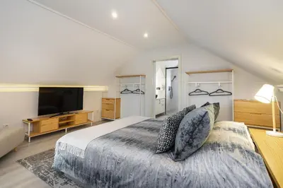 a bedroom with a large bed and a television at Douro Prestige Urban Retreat with shared S-Pool & Gym in Porto