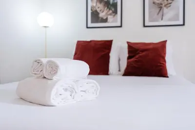 a pile of towels sitting on top of a bed at GuestReady - Almada 516 in Porto