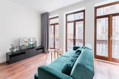 a living room with a couch and a tv at GuestReady - Almada 516 in Porto