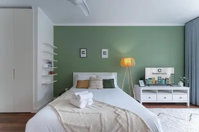 a bedroom with a bed with towels on it at GuestReady - Almada 516 in Porto