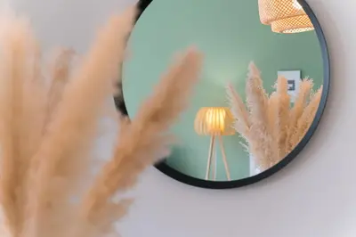 a mirror with a plant in front of a lamp at GuestReady - Almada 516 in Porto
