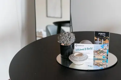 a black table with a book and a vase with flowers at GuestReady - Almada 516 in Porto