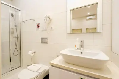 a white bathroom with a sink and a shower at GuestReady - Port Studio 4 in Vila Nova de Gaia