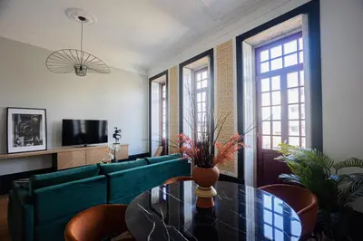 a living room with a green couch and a glass table at Amazing Family Flat in Center Porto in Porto