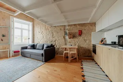 a living room with a couch and a table at Ribeira Charming Apartment in Porto