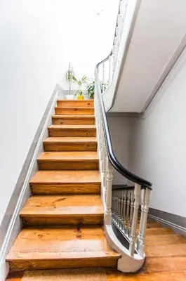 a staircase with wooden floors and a metal railing at InLapa Studio IV Porto Garden View in Porto