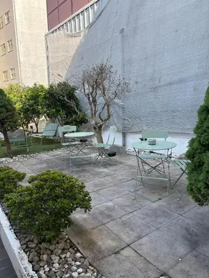 a row of benches in front of a building at InLapa Studio IV Porto Garden View in Porto