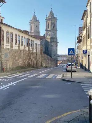 an empty street with a building and a clock tower at InLapa Studio V Porto Terrace in Porto
