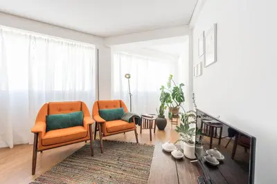 a living room with two chairs and a fireplace at GuestReady - Chic and cozy getaway in Porto