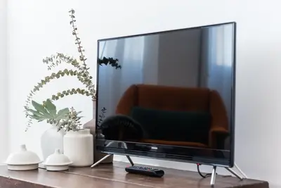 a flat screen tv sitting on a wooden table at GuestReady - Chic and cozy getaway in Porto