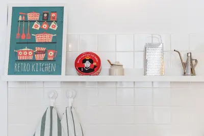 a shelf in a kitchen with kitchen utensils at GuestReady - Chic and cozy getaway in Porto
