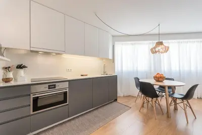 a kitchen with a table and a dining room at GuestReady - Chic and cozy getaway in Porto