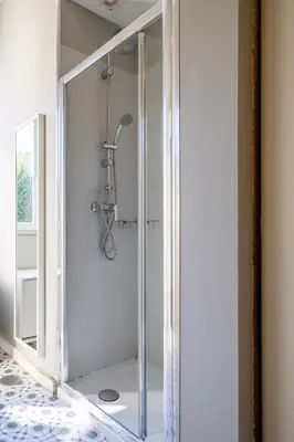 a shower with a glass door in a bathroom at Host Wise - Sweet Bright Flats - City Center in Porto