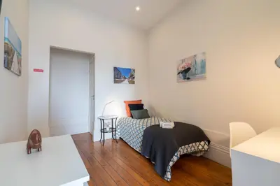 a bedroom with a bed and a table in it at Host Wise - Sweet Bright Flats - City Center in Porto