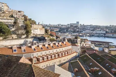 an aerial view of a city with a river and buildings at Timbre Virtudes in Porto