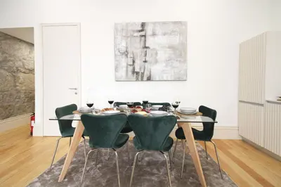 a dining room with a table and chairs at Porto Unique Downtown Garden in Porto