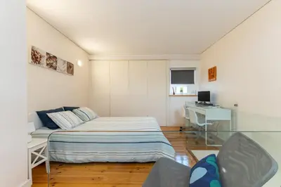 a small bedroom with a bed and a desk at Duke Street Guest House in Porto