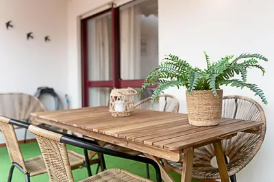 a wooden table with two potted plants on it at CityLiving in Porto