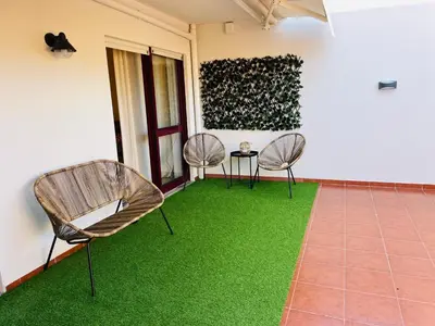 a room with two chairs and green grass at CityLiving in Porto