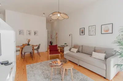 a living room with a couch and a table at Virtudes Flat w/ AC & Balcony by LovelyStay in Porto