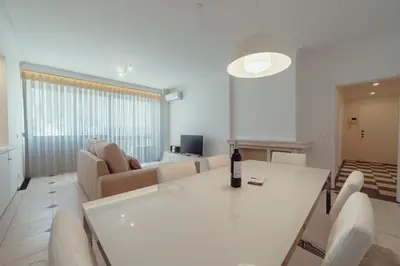 a living room with a white table and a couch at Grand Premium Boavista Apartment by Vacationy in Porto