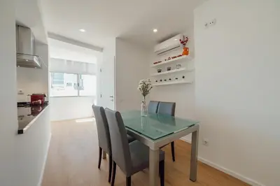 a dining room with a glass table and chairs at Grand Premium Boavista Apartment by Vacationy in Porto