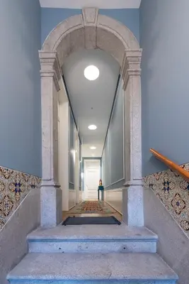 a hallway with an archway in a building at Blau 1911 in Porto