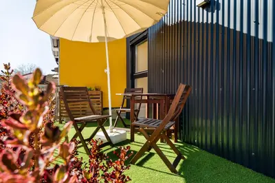 two chairs and a table with an umbrella at Casa Flora in Porto