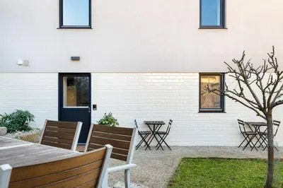 a patio with a table and chairs in front of a building at Casa Flora in Porto